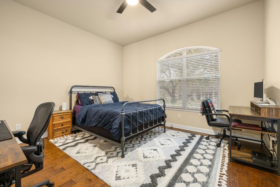 103 Kendall Road Spicewood, TX 78669 - Photo 22 of 37 a bedroom with furniture and a window