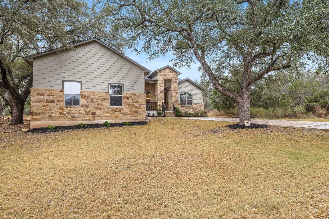 103 Kendall Road Spicewood, TX 78669 - Photo 3 of 37 a view of a house with a yard covered with snow