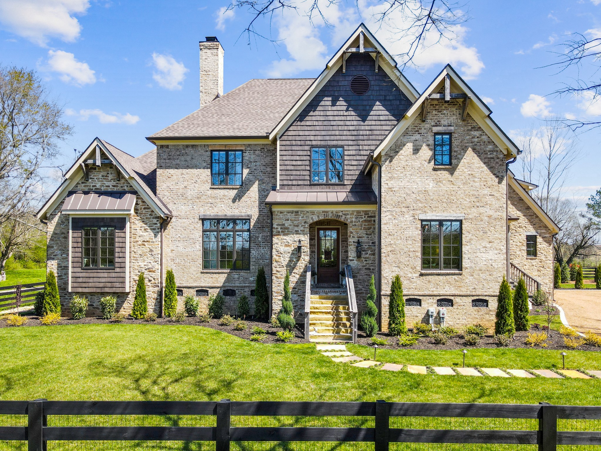 a front view of a house with garden