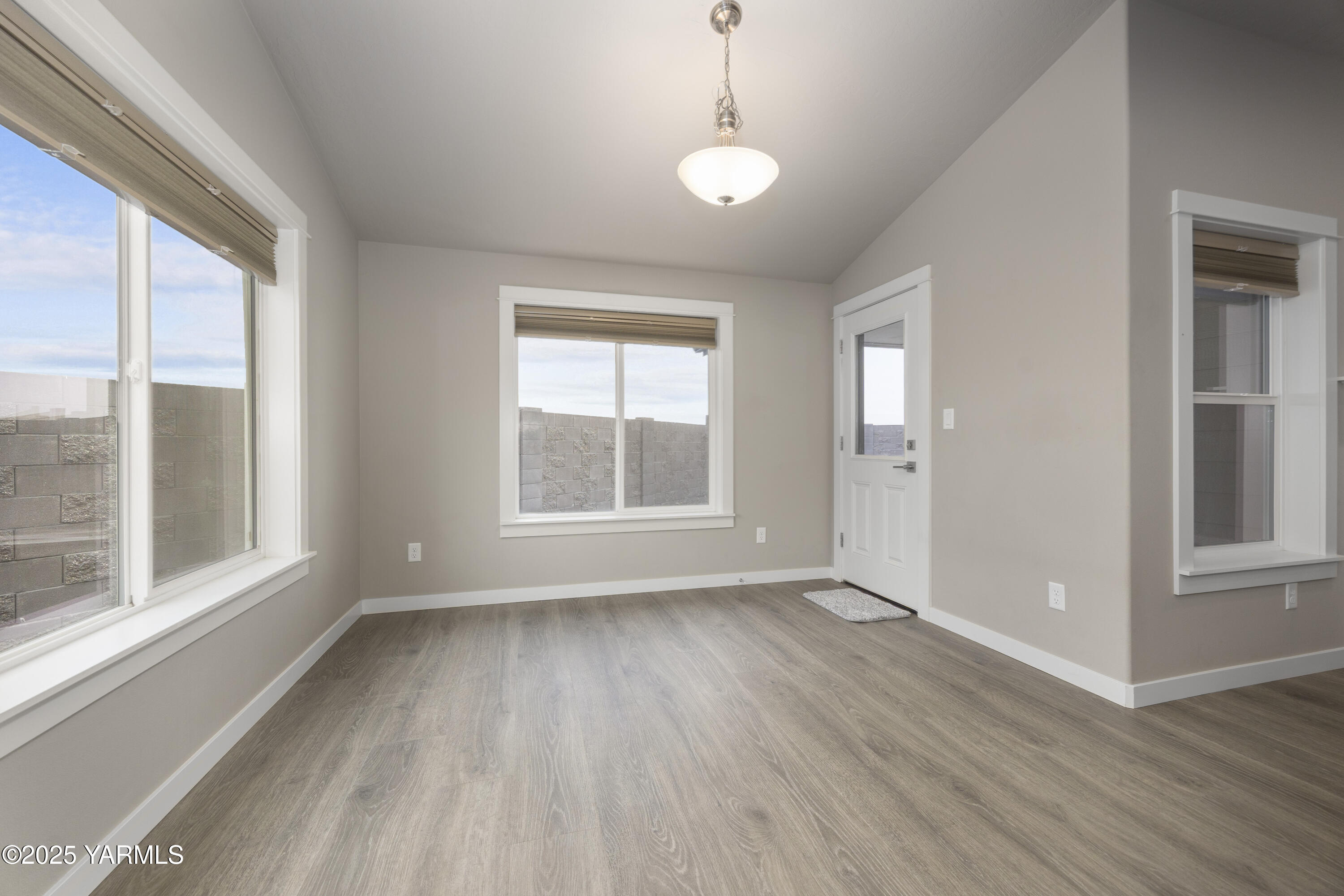 217 Rio Bravo Street Prosser, WA 99350 - Photo 11 of 44 an empty room with wooden floor and windows