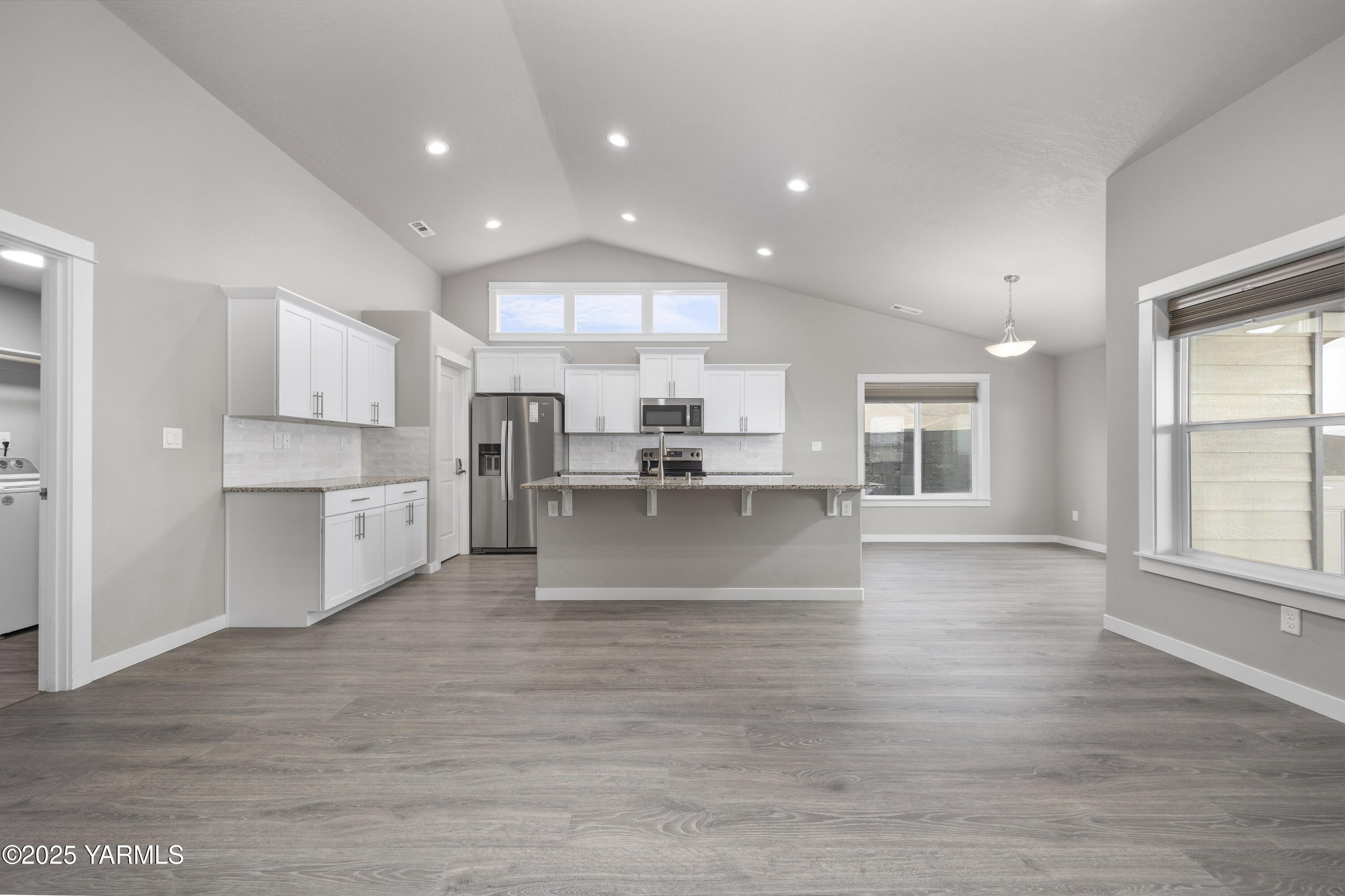 217 Rio Bravo Street Prosser, WA 99350 - Photo 17 of 44 a view of kitchen dining table chairs cabinets and wooden floor