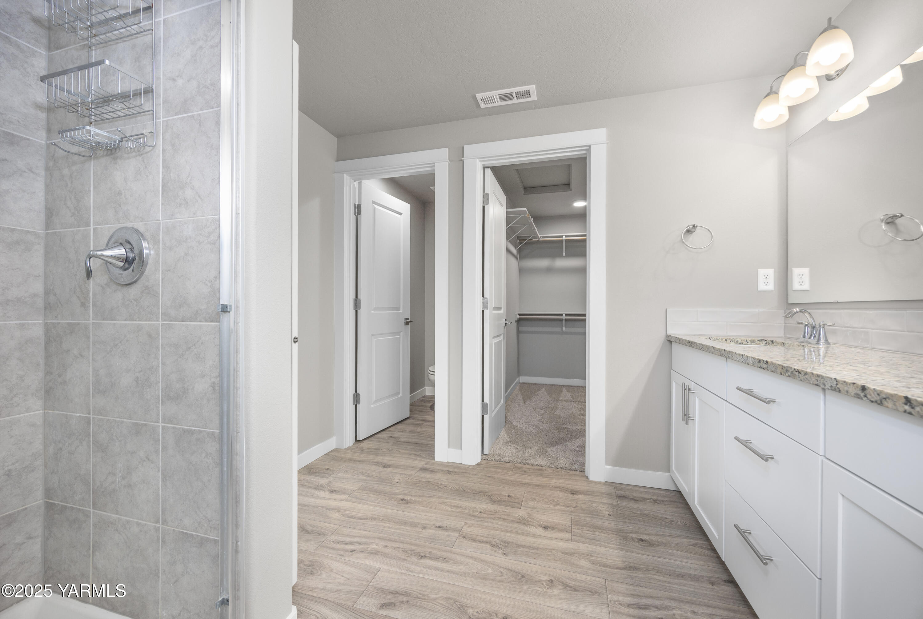 217 Rio Bravo Street Prosser, WA 99350 - Photo 18 of 44 a bathroom with a granite countertop sink a mirror and shower