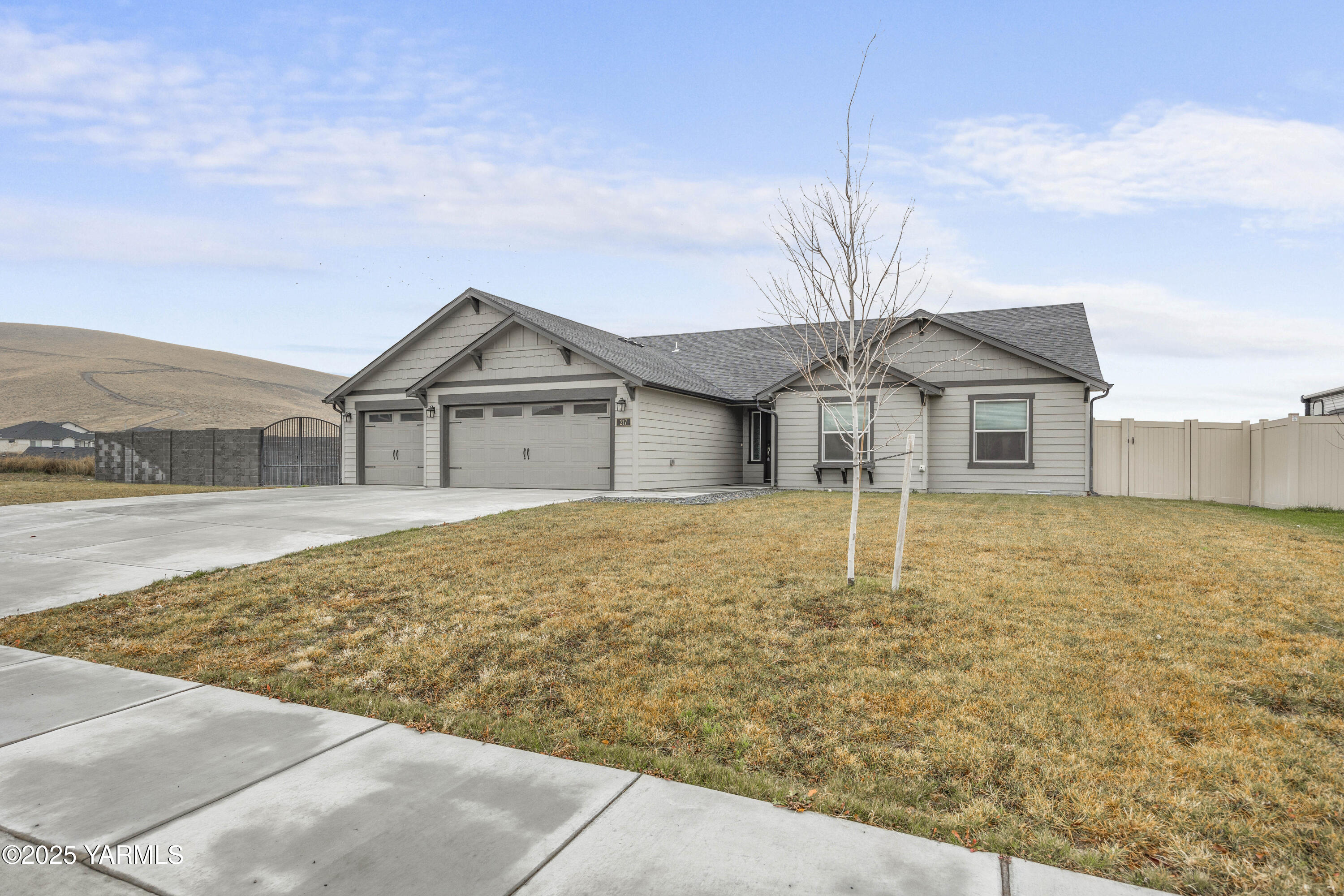 217 Rio Bravo Street Prosser, WA 99350 - Photo 40 of 44 a house with trees in front of it