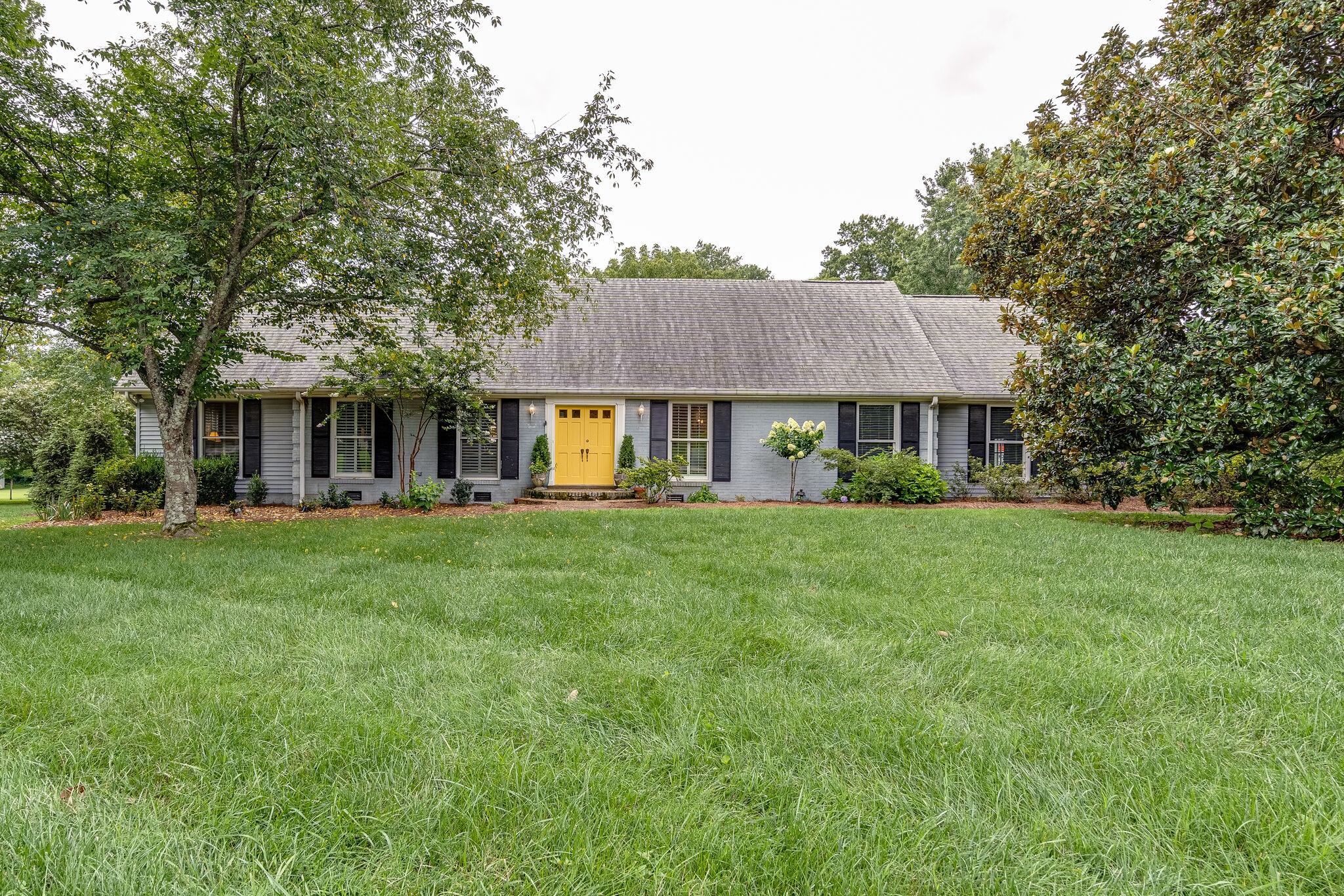 9017 Ford Drive Brentwood, TN 37027 - Photo 1 of 36 a front view of a house with a garden