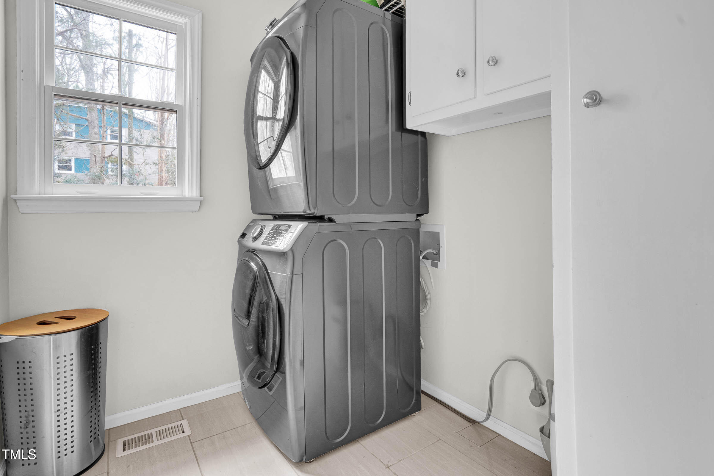 3312 Powers Lane Durham, NC 27712 - Photo 11 of 28 a view of walk in closet with window and wooden floor