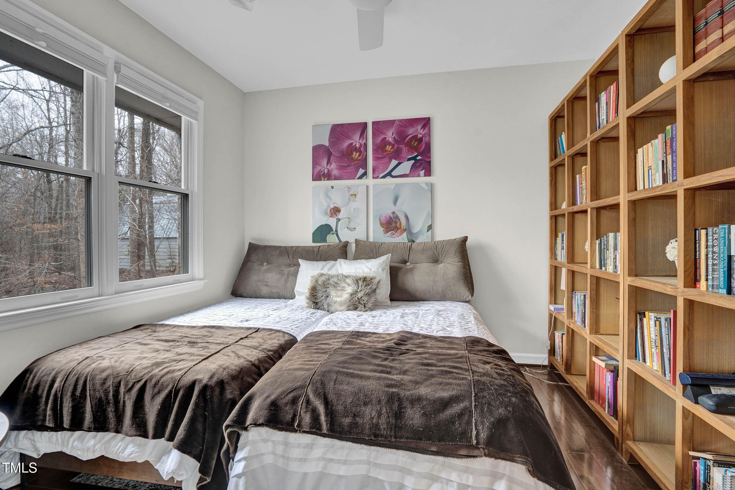 3312 Powers Lane Durham, NC 27712 - Photo 14 of 28 a bedroom with a bed a large window and book shelf