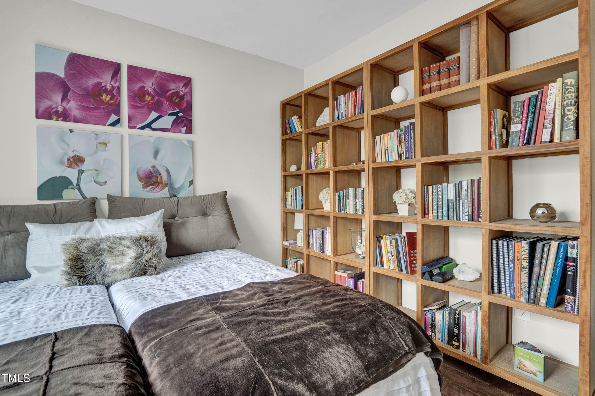 3312 Powers Lane Durham, NC 27712 - Photo 15 of 28 a bedroom with a bed a book shelf and a book shelf