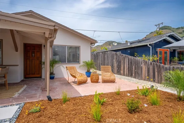 a view of a patio with table and chairs with wooden fence