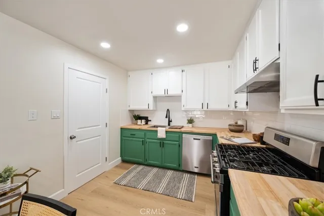 a kitchen with a sink stove and refrigerator