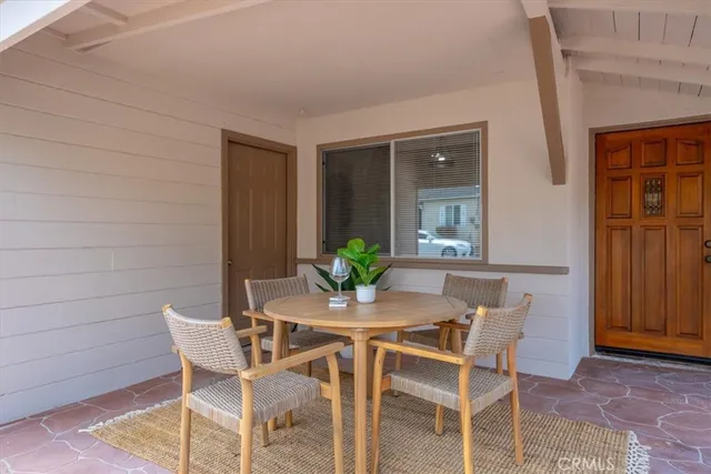 a view of a dining room with furniture and a potted plant