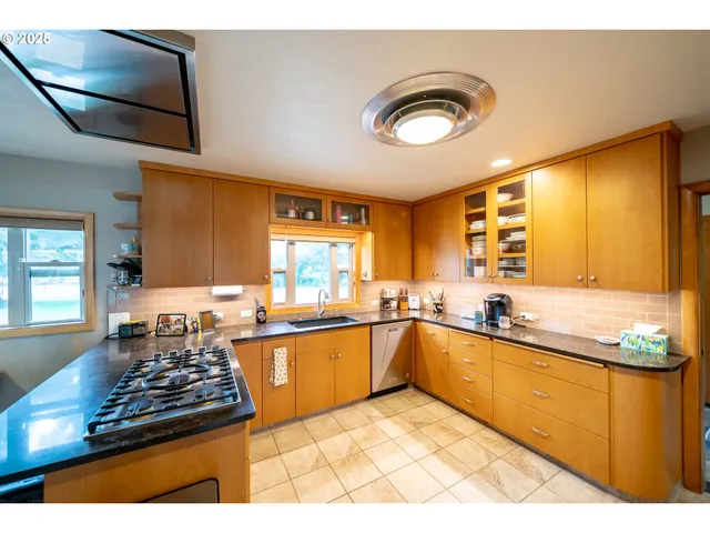 a kitchen with lots of counter top space and a window