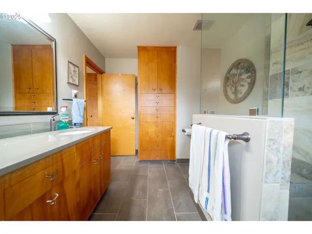 a bathroom with a sink a toilet and a shower