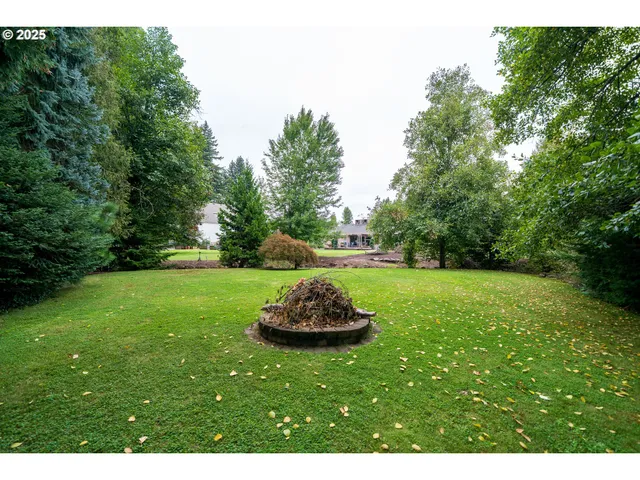 a big yard with swimming pool and green space