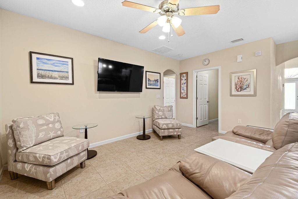 1728 Berkshire Circle Southwest Vero Beach, FL 32968 - Photo 11 of 36 a living room with furniture and a flat screen tv