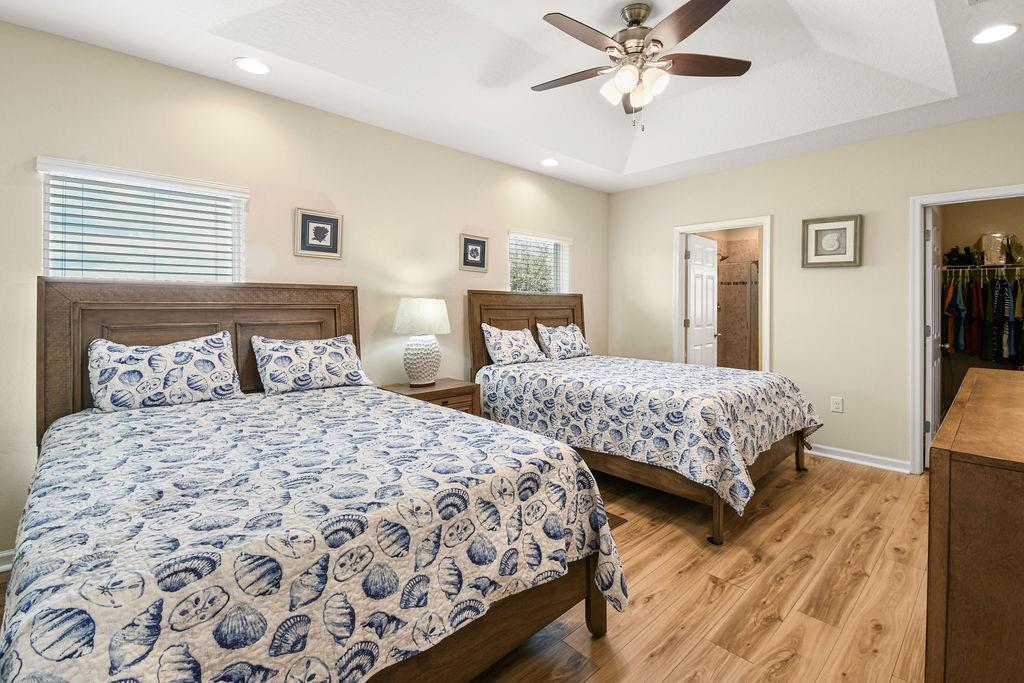 1728 Berkshire Circle Southwest Vero Beach, FL 32968 - Photo 18 of 36 a bedroom with two separate beds and a chandelier
