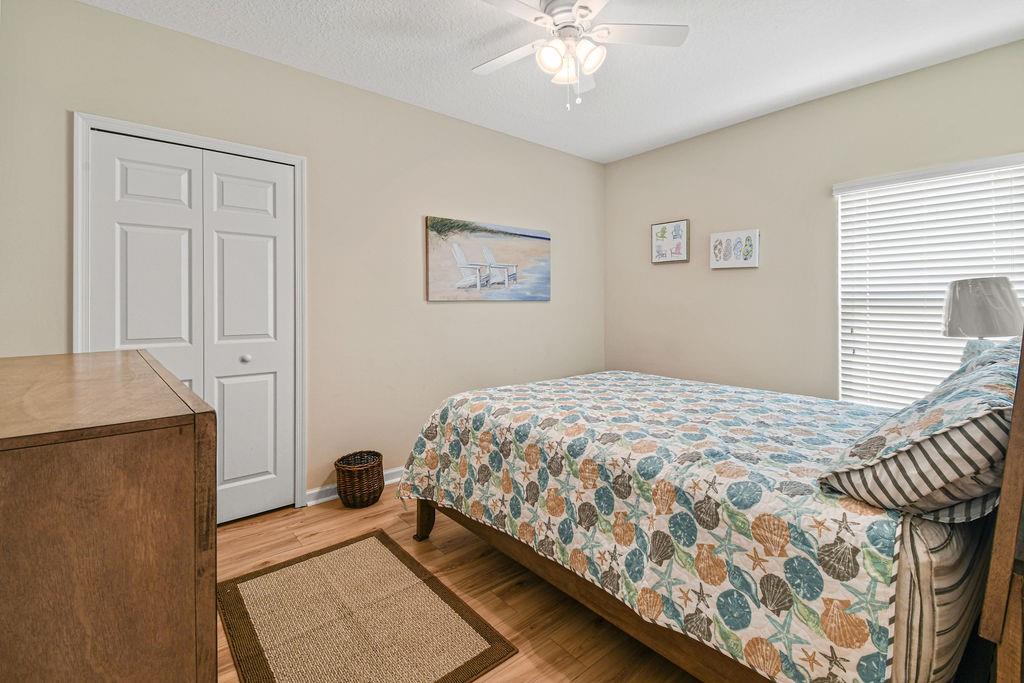 1728 Berkshire Circle Southwest Vero Beach, FL 32968 - Photo 24 of 36 a bedroom with a bed and a chandelier