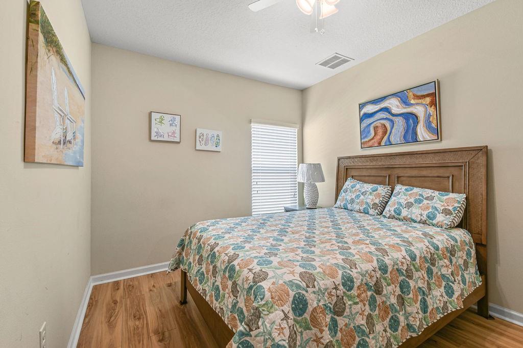 1728 Berkshire Circle Southwest Vero Beach, FL 32968 - Photo 25 of 36 a bedroom with a bed and painting on the wall