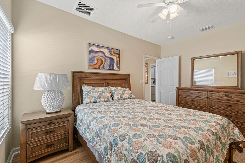 1728 Berkshire Circle Southwest Vero Beach, FL 32968 - Photo 26 of 36 a bedroom with a bed and a dresser
