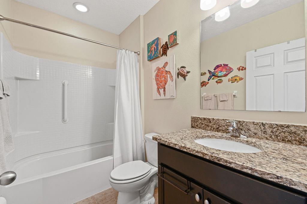 1728 Berkshire Circle Southwest Vero Beach, FL 32968 - Photo 27 of 36 a bathroom with a granite countertop sink a toilet and a shower