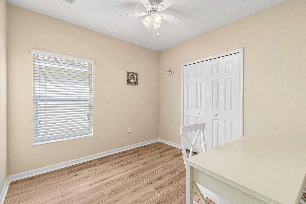 1728 Berkshire Circle Southwest Vero Beach, FL 32968 - Photo 28 of 36 a view of an empty room with wooden floor and a window