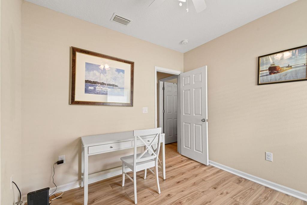 1728 Berkshire Circle Southwest Vero Beach, FL 32968 - Photo 29 of 36 a workspace room with wooden floor and windows
