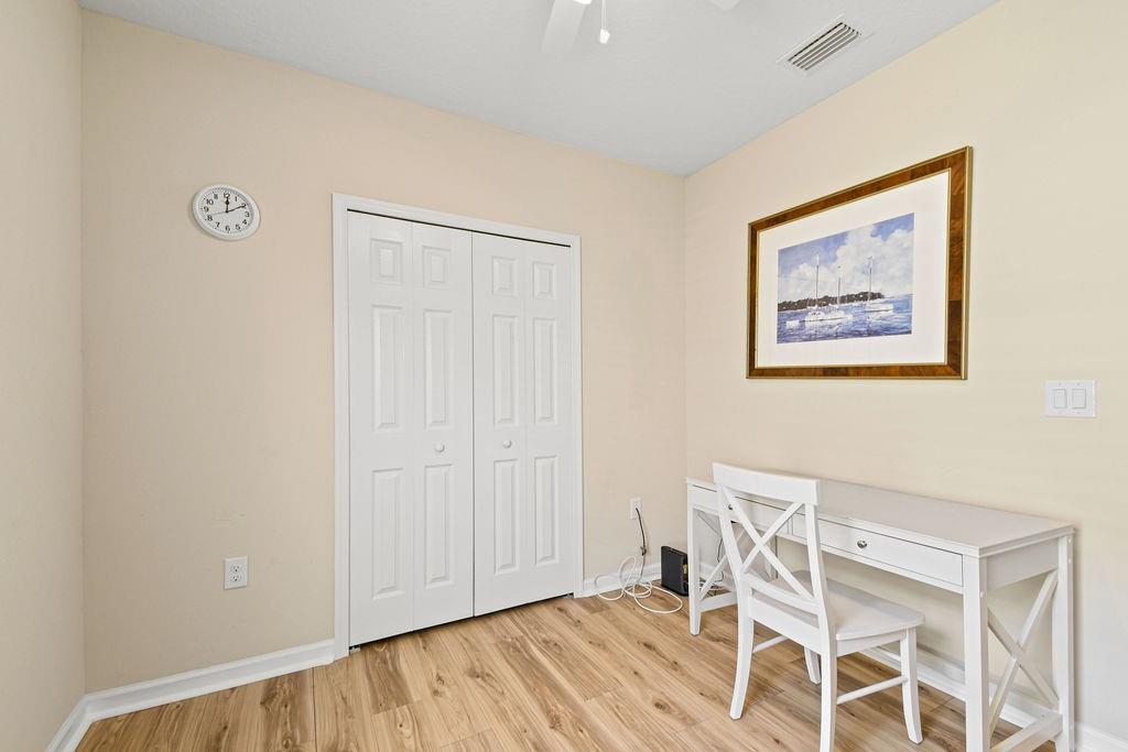 1728 Berkshire Circle Southwest Vero Beach, FL 32968 - Photo 30 of 36 a view of an empty room with wooden floor
