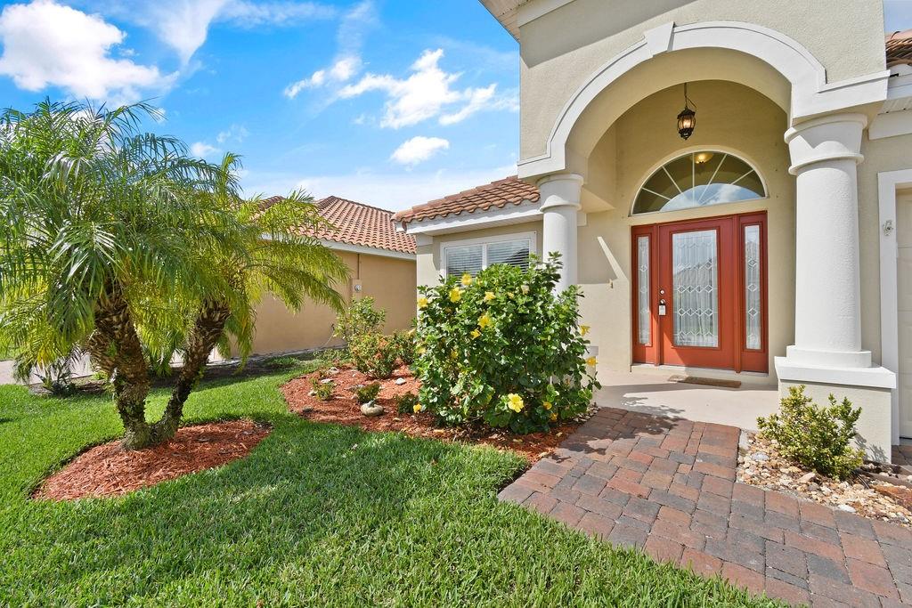 1728 Berkshire Circle Southwest Vero Beach, FL 32968 - Photo 3 of 36 a front view of a house with garden