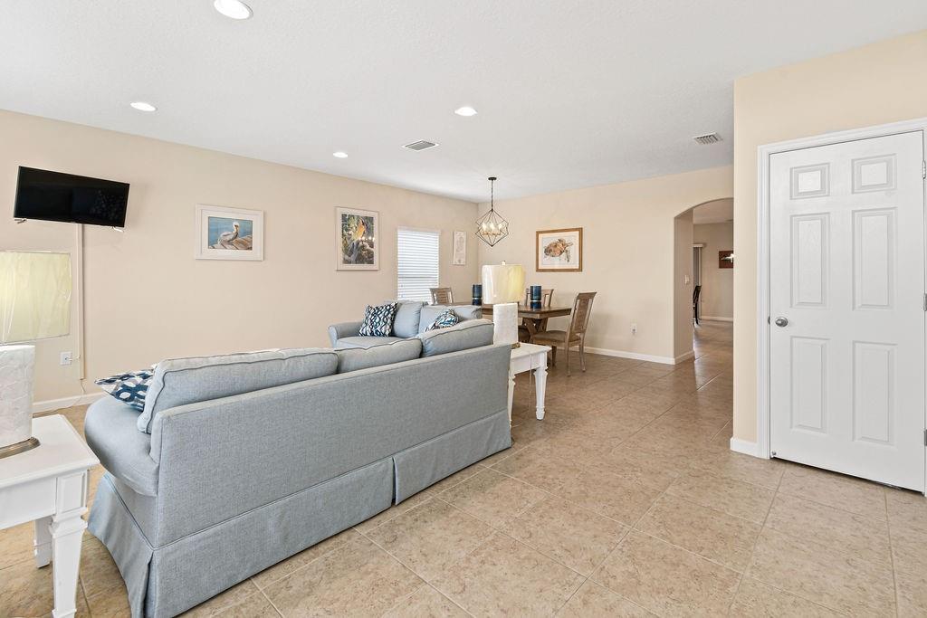 1728 Berkshire Circle Southwest Vero Beach, FL 32968 - Photo 4 of 36 a living room with furniture and a flat screen tv