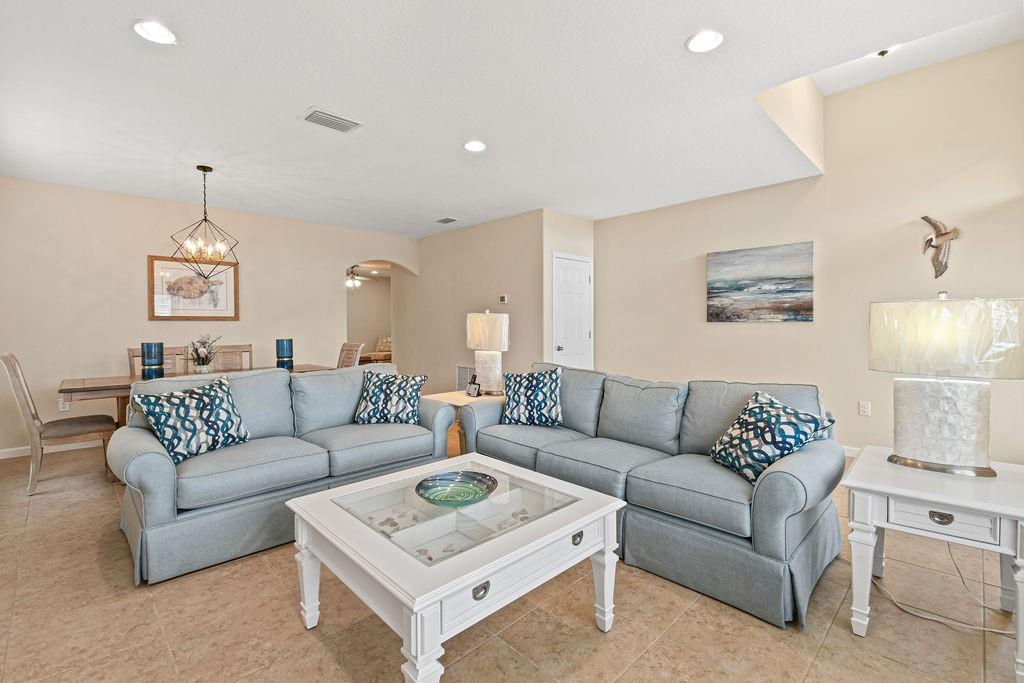 1728 Berkshire Circle Southwest Vero Beach, FL 32968 - Photo 7 of 36 a living room with furniture and a chandelier