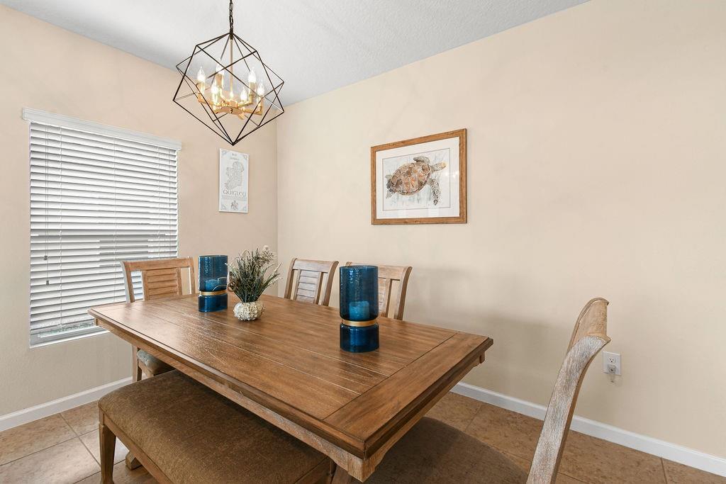 1728 Berkshire Circle Southwest Vero Beach, FL 32968 - Photo 8 of 36 a view of a dining room with a table and chairs