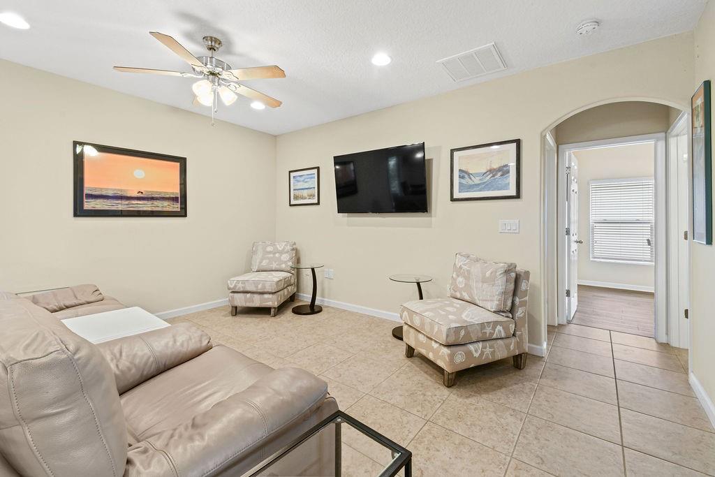 1728 Berkshire Circle Southwest Vero Beach, FL 32968 - Photo 10 of 36 a living room with furniture and a flat screen tv