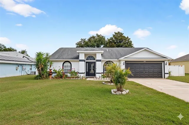 a front view of a house with a yard and garage