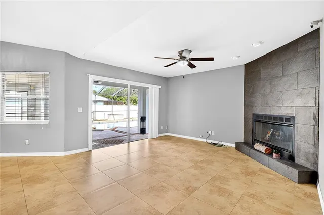 a view of an empty room with a fireplace and a window