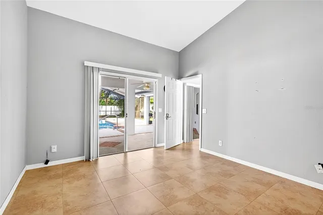 an empty room with entrance and view of hallway