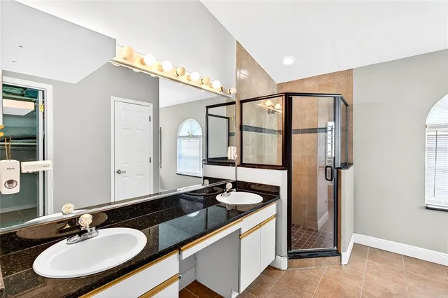a bathroom with a sink double vanity and a mirror