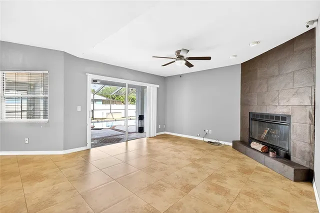 a view of an empty room with a fireplace and a window