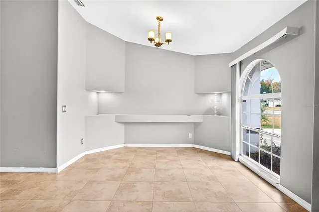 a view of empty room with window and ceiling fan