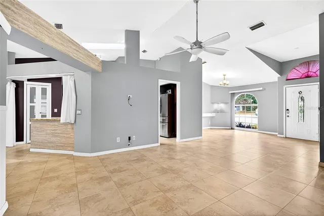 a view of an empty room with a ceiling fan
