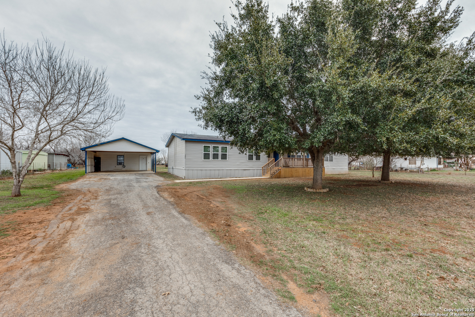 380 Bluefield Drive Pleasanton, TX 78064 - Photo 1 of 1 a view of a house with large trees and fence