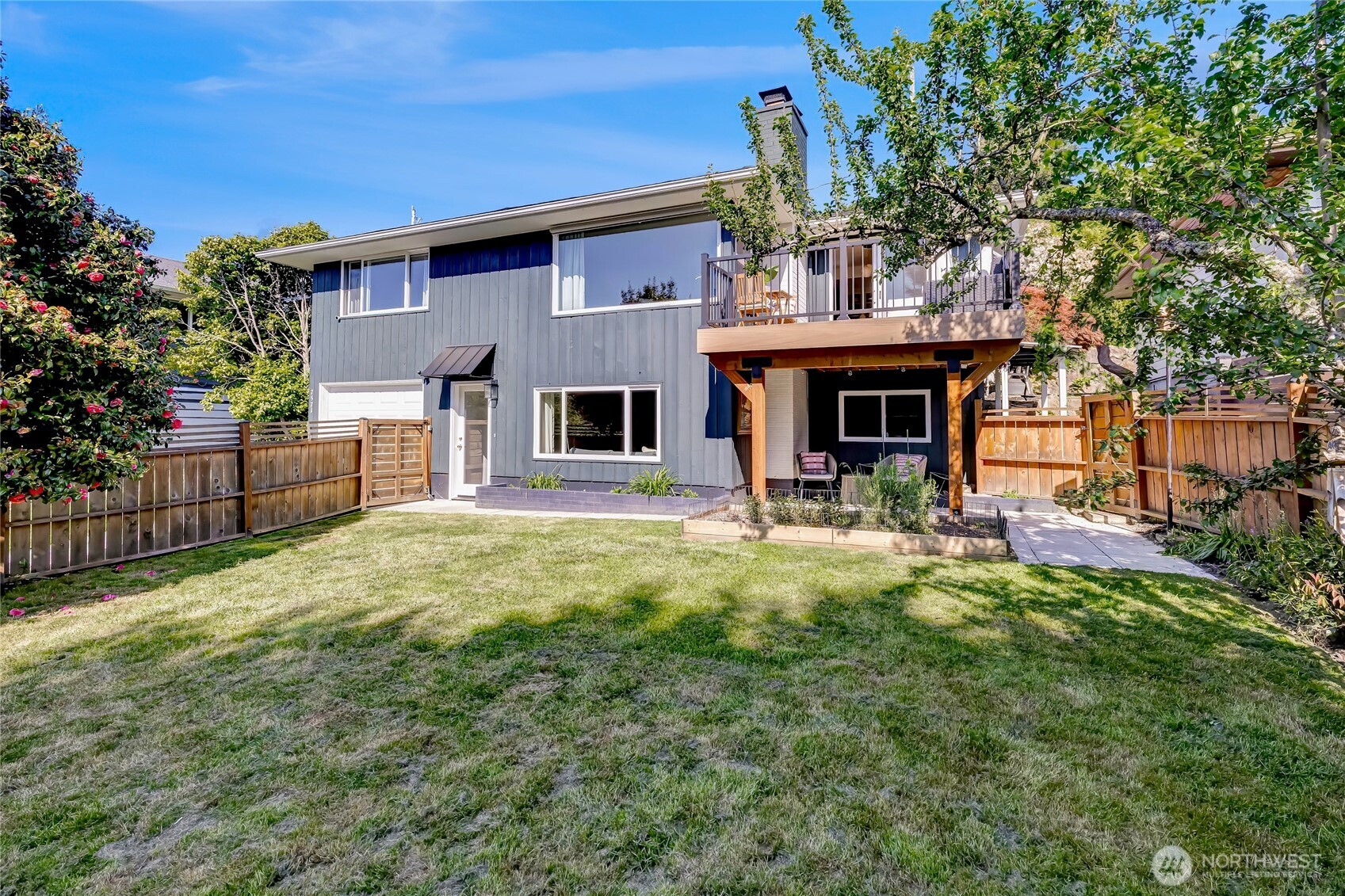 7571 45th Avenue Southwest Seattle, WA 98136 - Photo 39 of 40 a view of a house with a backyard and a fireplace