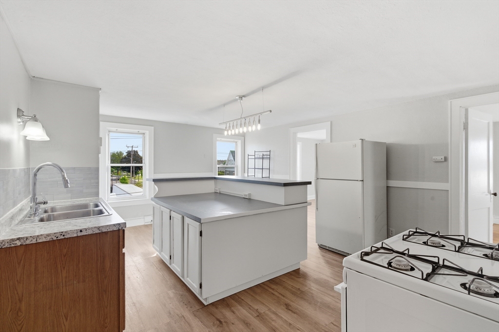 293 Clemente Street, Unit 3R Holyoke, MA 01040 - Photo 1 of 14 a kitchen with stainless steel appliances granite countertop a sink stove and refrigerator