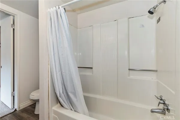 a bathroom with a shower curtain and a toilet