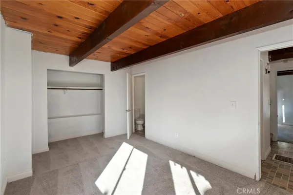 a bathroom with a granite countertop sink a toilet and mirror