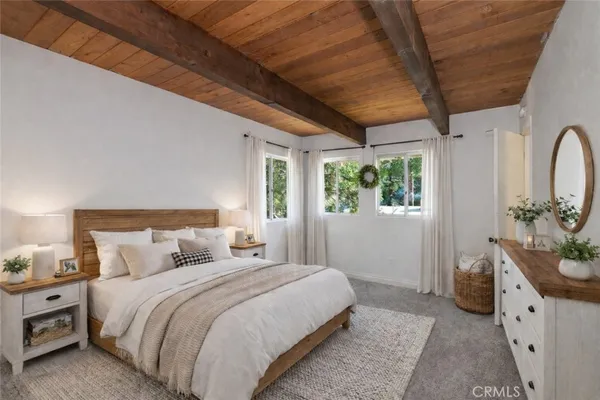 a balcony with wooden floor and trees in the back