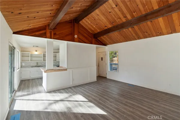 a view of a room with wooden floor