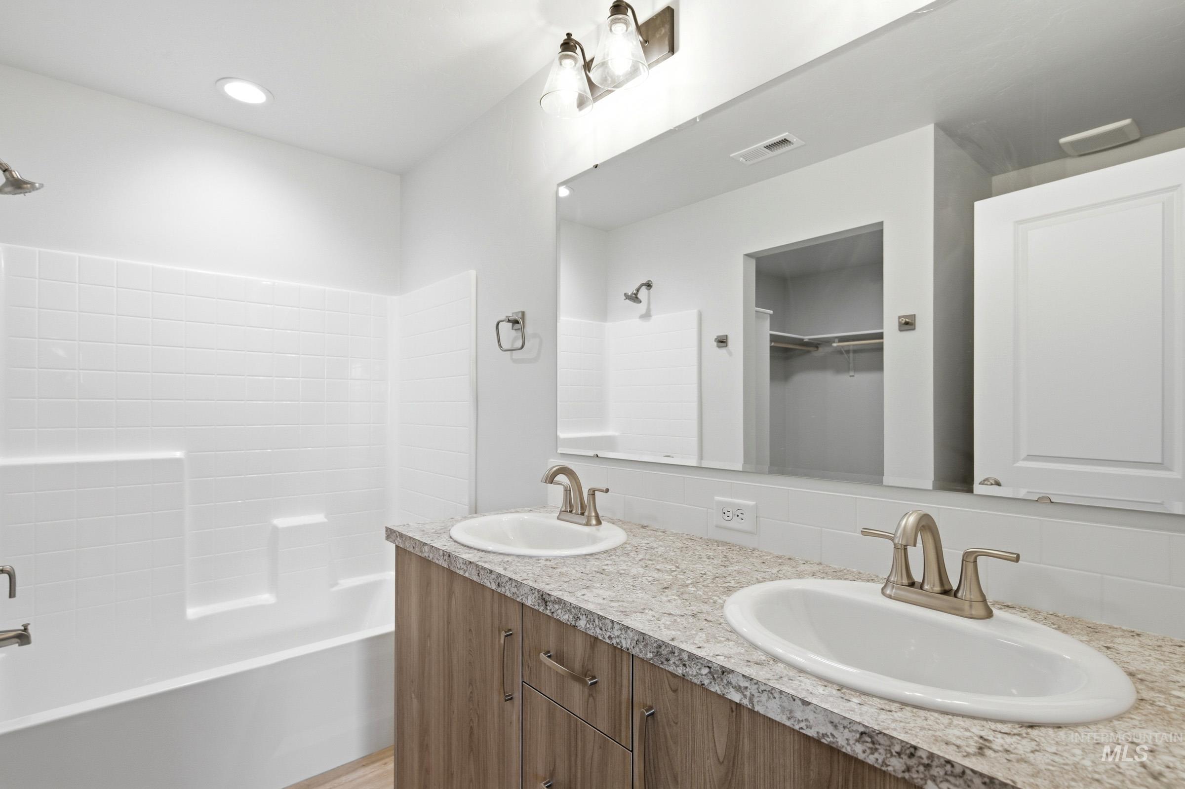 16632 North Shorthorn Loop Nampa, ID 83651 - Photo 16 of 17 Double vanity with wood-finish cabinetry, light-toned countertop, and dual undermount sinks