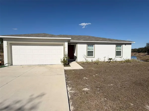 a view of garage and yard