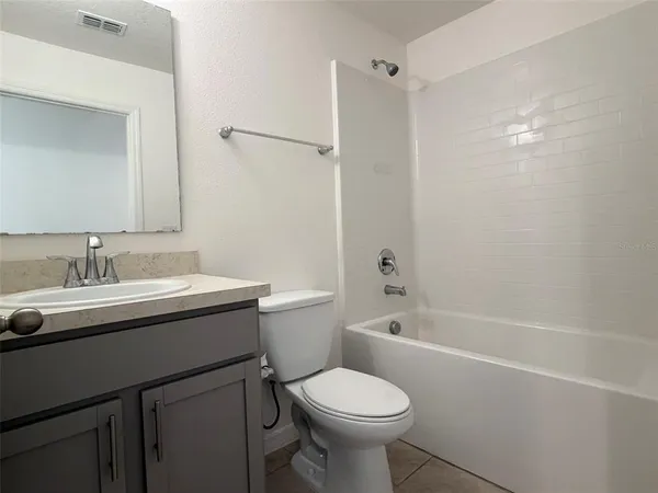 a bathroom with a sink toilet vanity and shower
