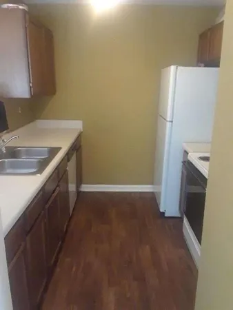 a kitchen with a sink and a refrigerator
