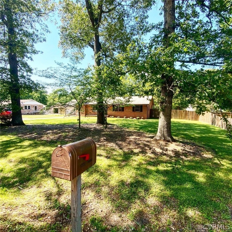 4210 Treely Road Chester, VA 23831 - Photo 2 of 39 a street view of a yard with plants and trees